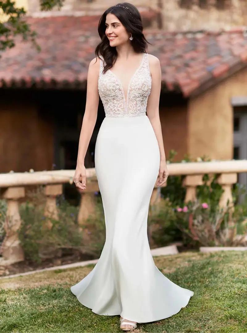 Model wearing Ella Rosa wedding dress, style BE547.
